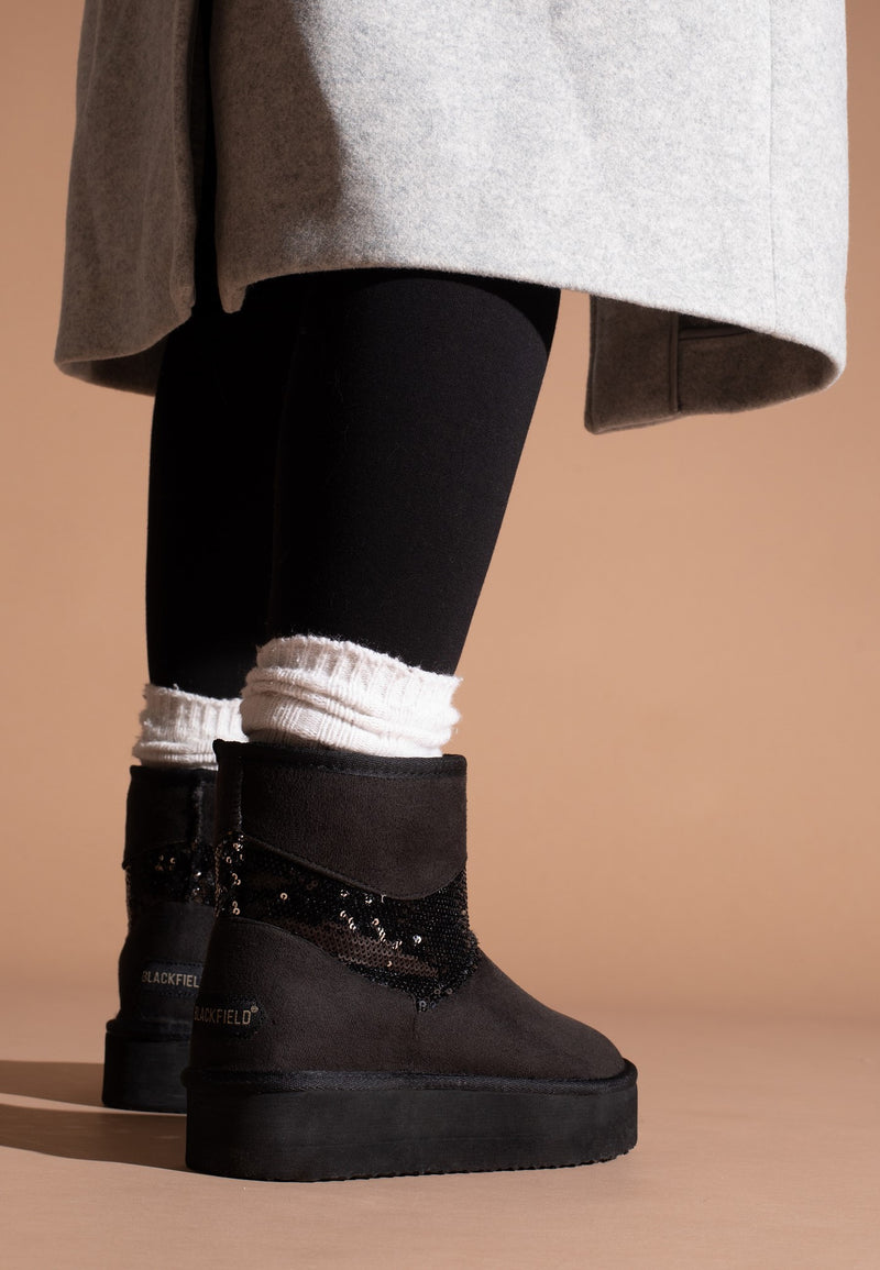 Bottines fourrées Garthage noires portées de dos, sequins et étiquette Blackfield visibles