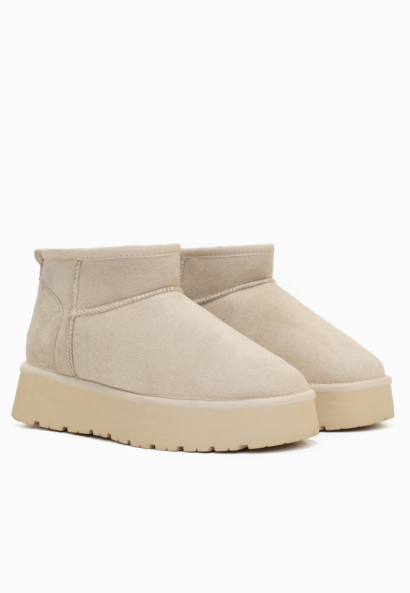 Duo de bottines fourrées Milli blanc cassé de trois-quarts, plateforme écrue crantée