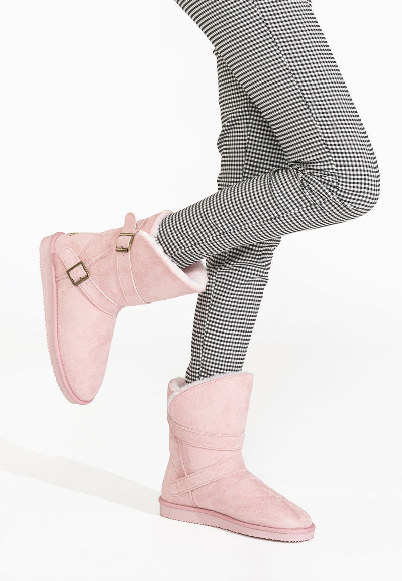 Bottines fourrées Camphor rose portées en marche sur un pantalon pied-de-poule