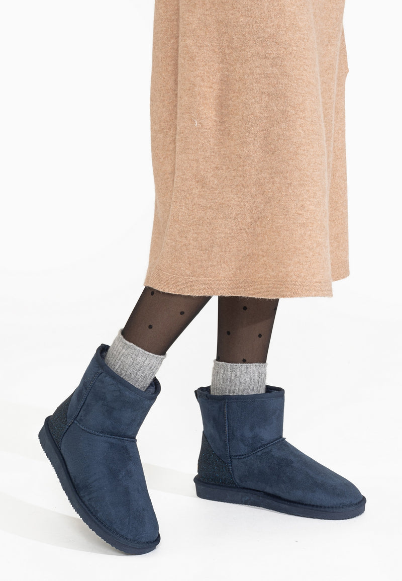 Bottines fourrées Casablanca marine portées en marche, chaussettes grises débordant de la tige