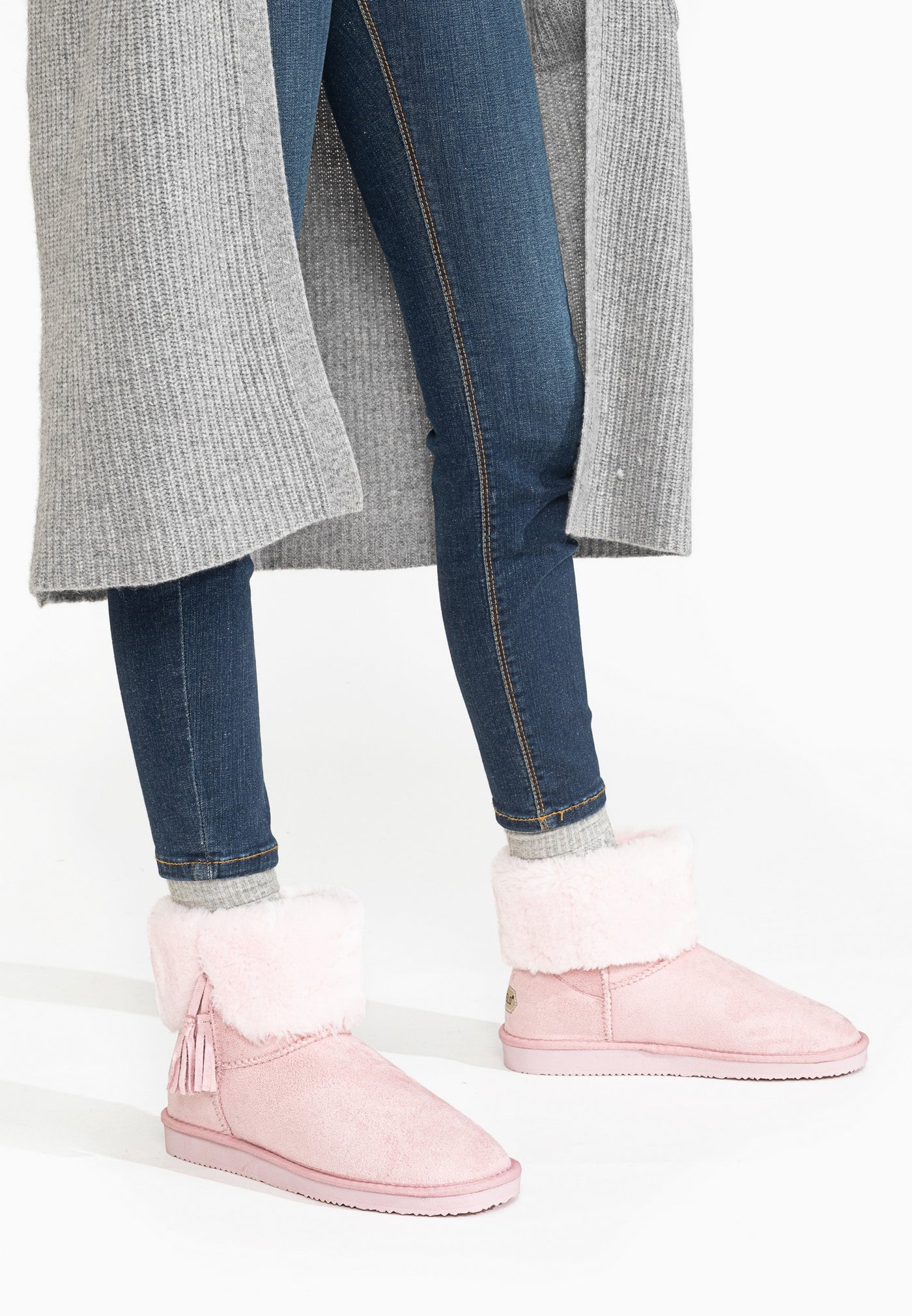 Bottines fourrées Clary roses portées avec un jean brut et un long gilet gris