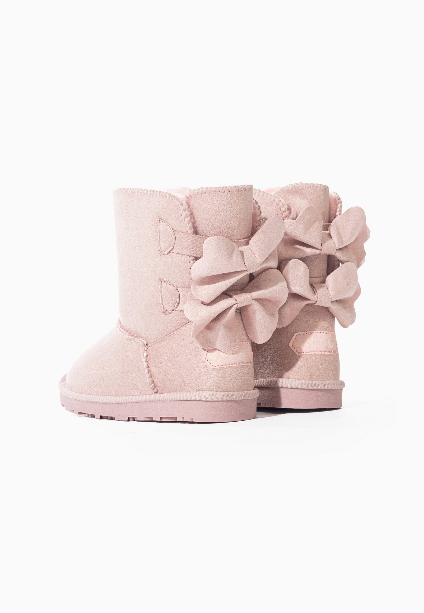 Bottes fourrées Edison rose vues de dos, quatre nœuds noués en microfibre plissée