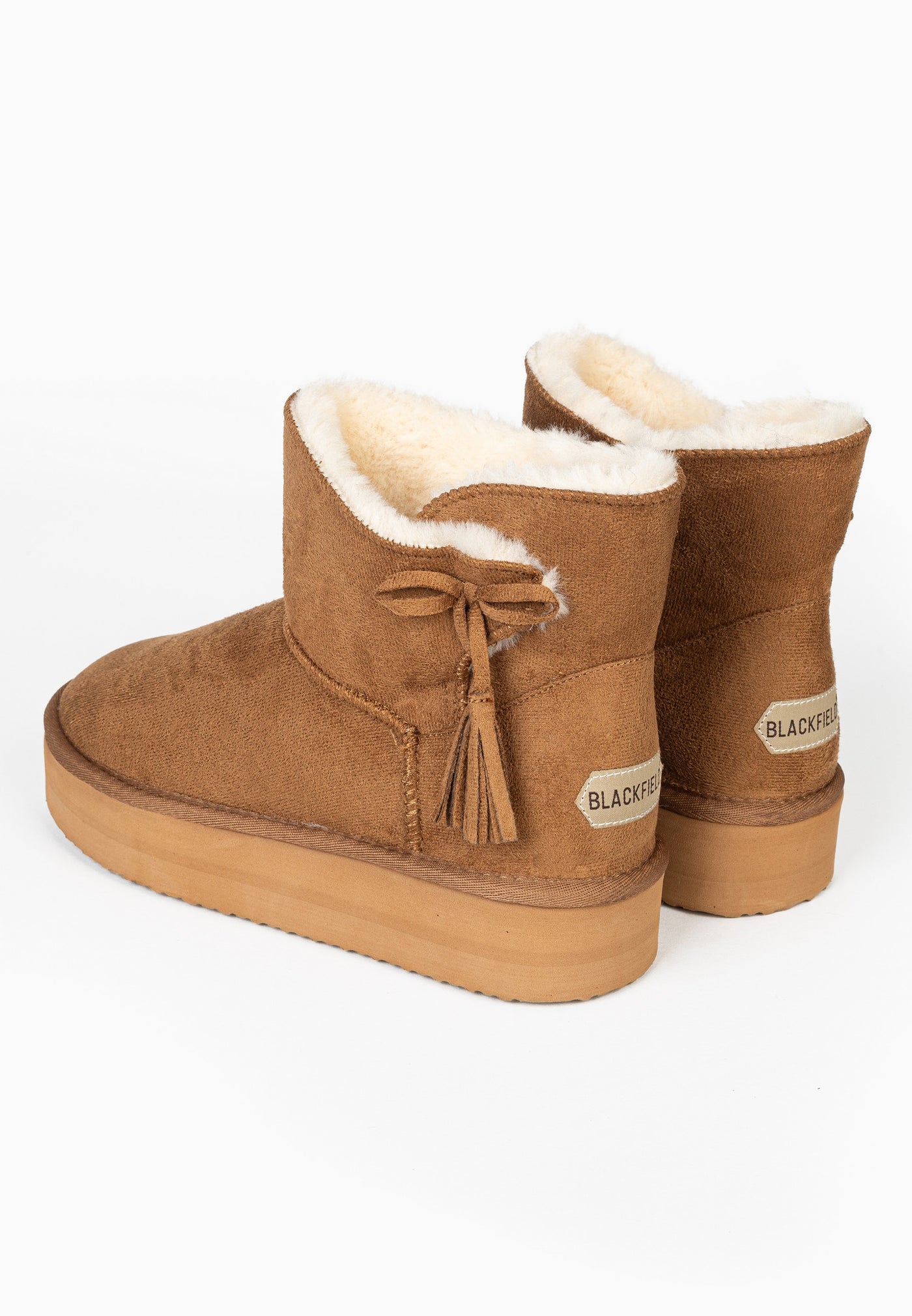 Deux bottines fourrées Curry camel vues de dos, glands à franges et col replié